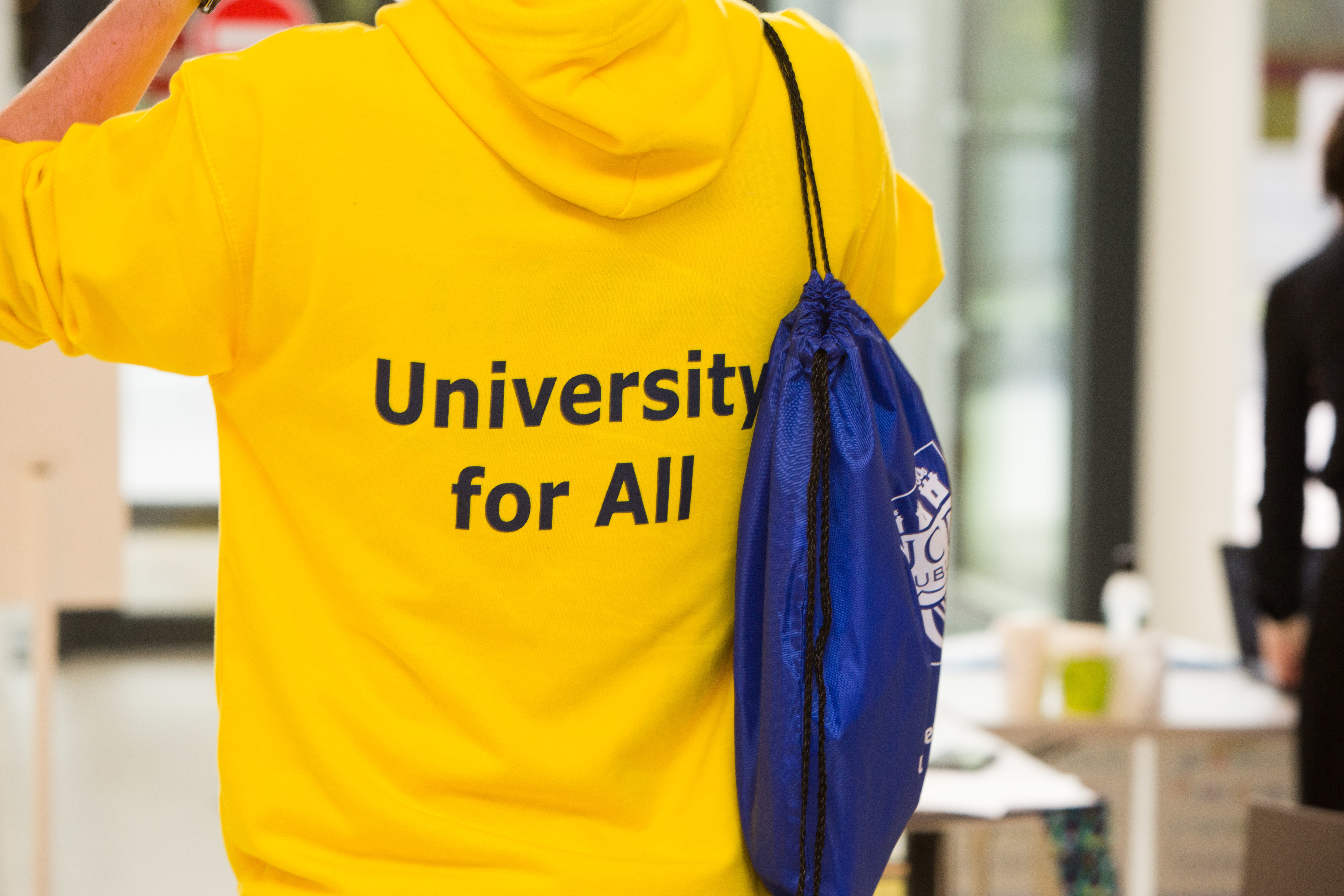 Back of a yellow hoody saying 