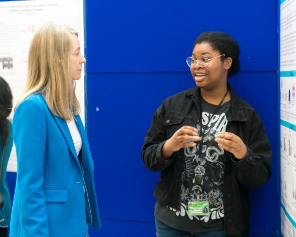 A student explains poster to VPRII Lorraine Brennan