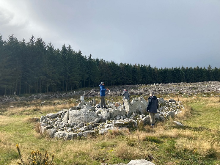 People beside rocks in mountain landscape