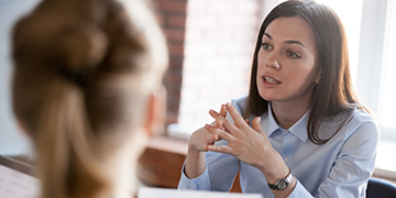 Image of two people talking