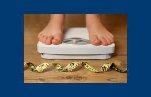 Shot of persons feet standing on scales with tape measurer