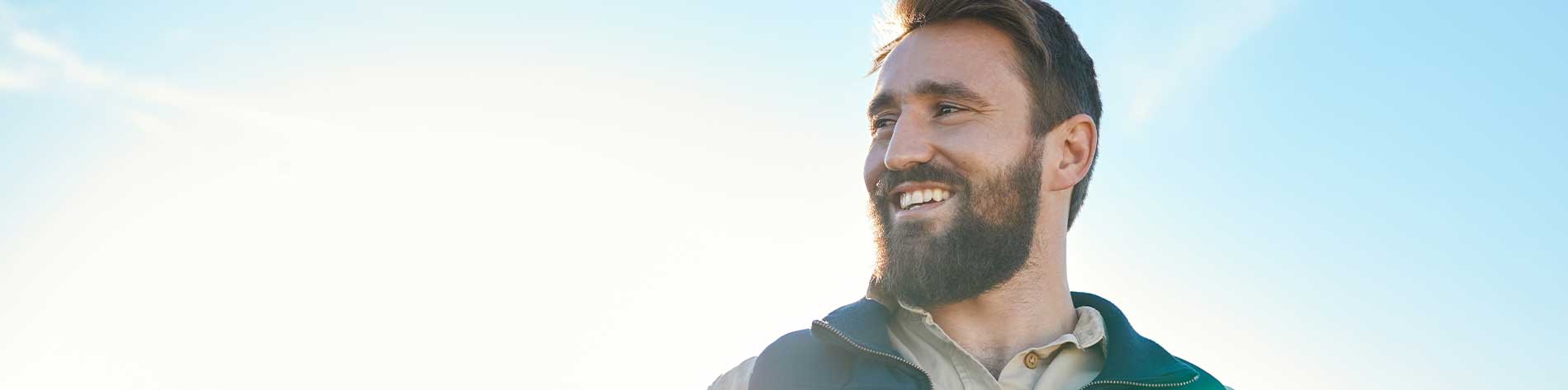 Man smiling out in a field.