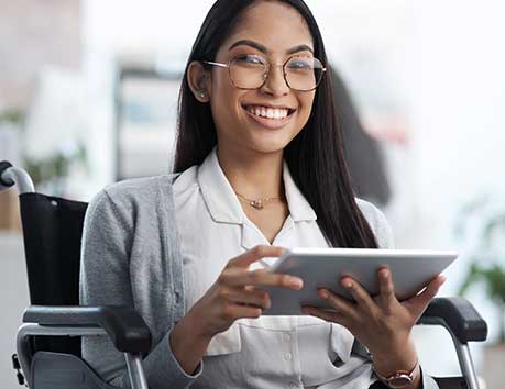 Woman in a wheelchair holding a tablet.