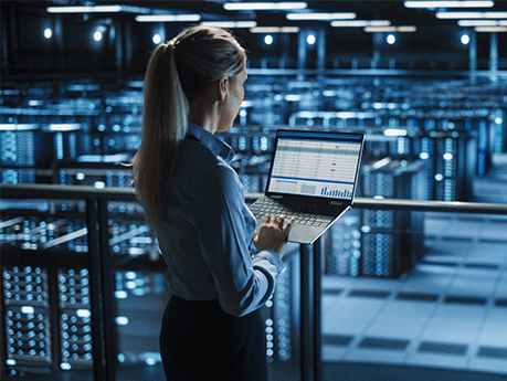 woman looking at laptop in software warehouse