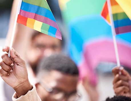 People waving rainbow flags.