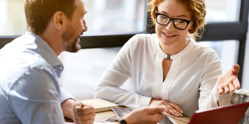 Image of two staff talking