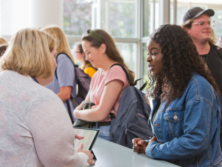 A UCD Access & Lifelong Learning staff member assisting a student